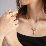 woman in black tube top wearing gold necklace